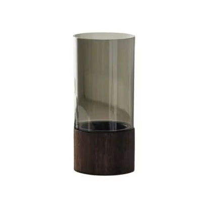The Atelier Vase in smoke-tinted acrylic with a dark wood round base